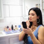 Women applying makeup in an organized bathroom